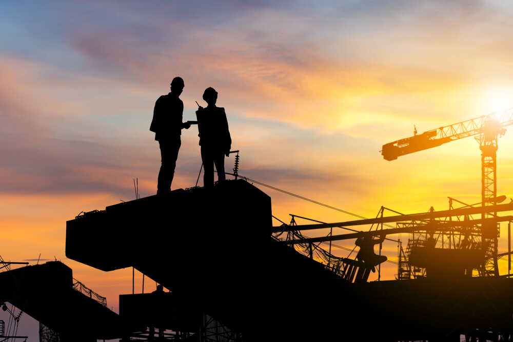 Site team silhouetted at sunset on a major UK groundworks and infrastructure project